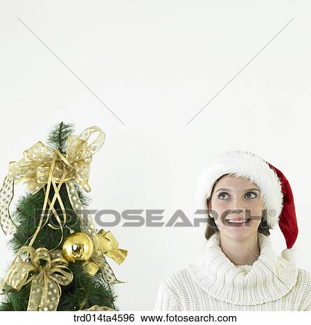 A woman wearing Santa Claus' hat View Large Photo Image Stock Photograph - A woman wearing Santa Claus' hat. Fotosearch
