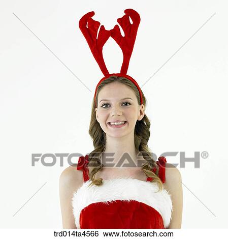 Stock Photograph - Christmas decoration and a woman wearing Santa Claus' clothes. Fotosearch