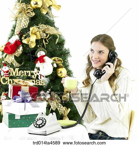 Stock Photo - Christmas decoration and Gift and a calling woman. Fotosearch