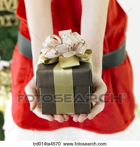 Christmas gift, a woman wearing Santa Claus' clothes View Large Photo Image Stock Image - Christmas gift, a woman wearing Santa Claus' clothes. Fotosearch