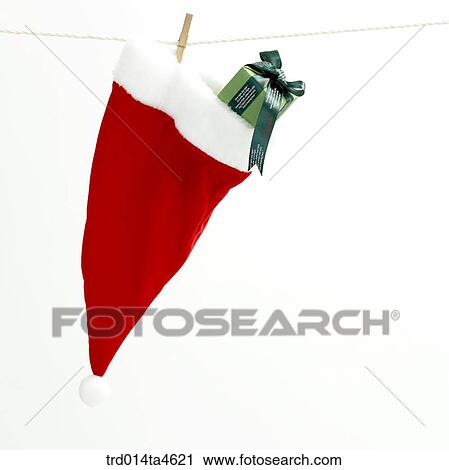 Christmas stuff, Santa Claus' hat and a gift box View Large Photo Image Stock Image - Christmas stuff, Santa Claus' hat and a gift box. Fotosearch