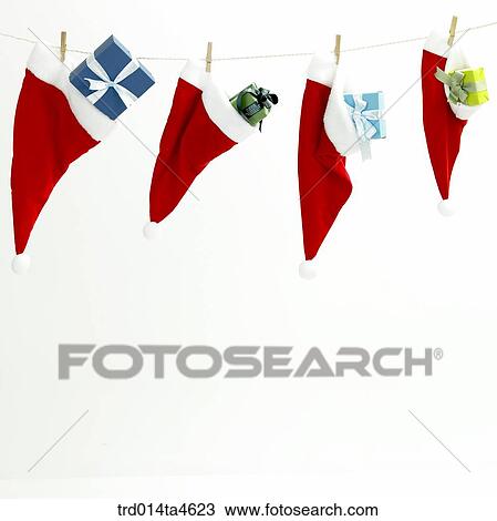 Stock Image - Christmas stuff, Santa Claus' hat and a gift box. Fotosearch