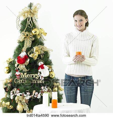 Christmas Tree, a woman holding a candle View Large Photo Image Stock Image - Christmas Tree, a woman holding a candle. Fotosearch