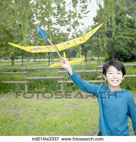 Stock Photo - boy playng with model plane. Fotosearch