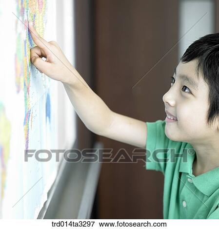 Stock Photo - Boy pointing map with his finger. Fotosearch