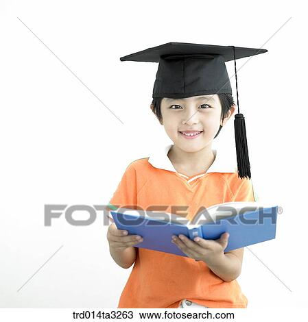 Boy reading books with graduation cap View Large Photo Image Stock Image - Boy reading books with graduation cap. Fotosearch