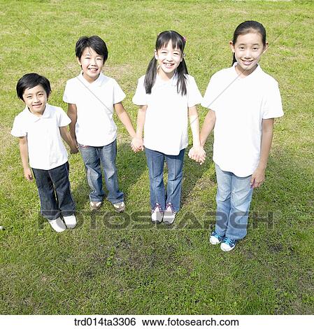 Children holding hands each other and line up at the park View Large Photo Image Stock Photograph - Children holding hands each other and line up at the park. Fotosearch