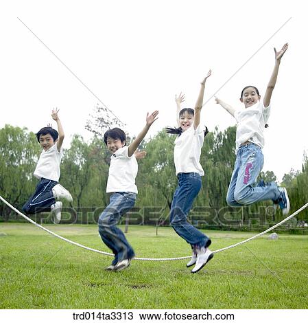Children jumping ropes at the park View Large Photo Image Stock Image - Children jumping ropes at the park. Fotosearch
