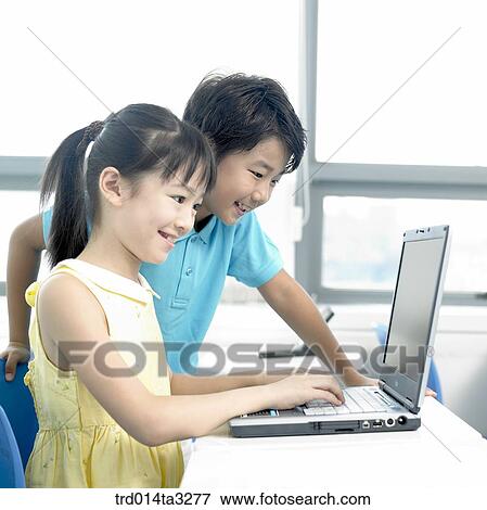 Children looking at notebook computer View Large Photo Image Stock Photo - Children looking at notebook computer. Fotosearch