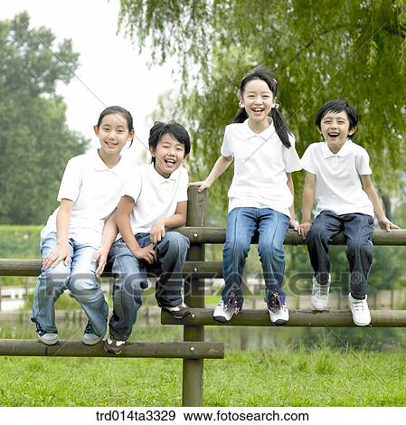 children sitting on the fence View Large Photo Image Stock Photo - children sitting on the fence. Fotosearch