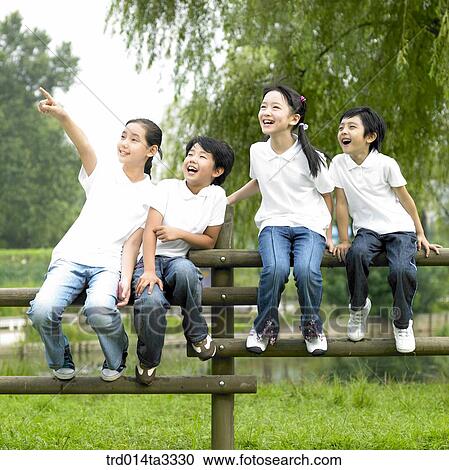 children sitting on the fence with pointing out mountain View Large Photo Image Stock Image - children sitting on the fence with pointing out mountain. Fotosearch