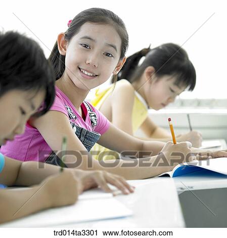 Stock Image - Children taking notes. Fotosearch