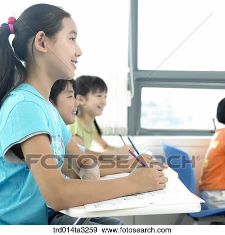 Stock Photo - Children taking notes. Fotosearch