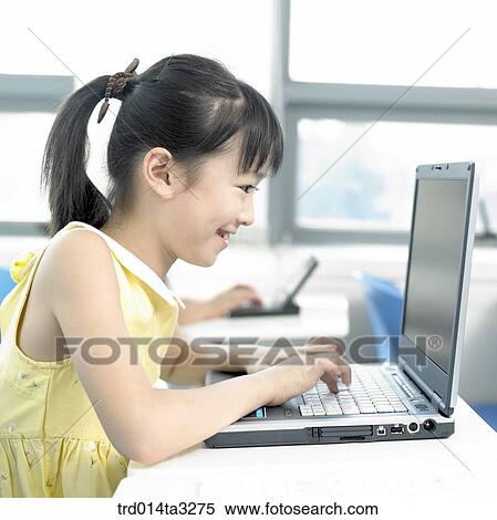Stock Photography - Girl looking at notebook computer. Fotosearch