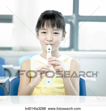 Stock Photo - Girl playing recorder. Fotosearch