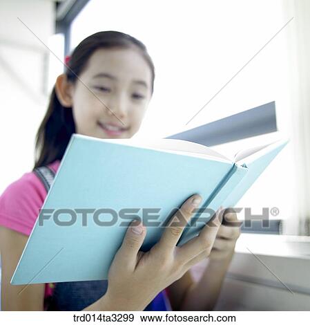 Stock Photo - Girl reading books. Fotosearch