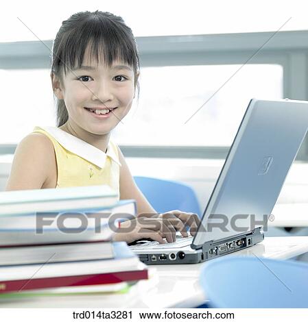 Stock Image - Girl using notebook computer. Fotosearch