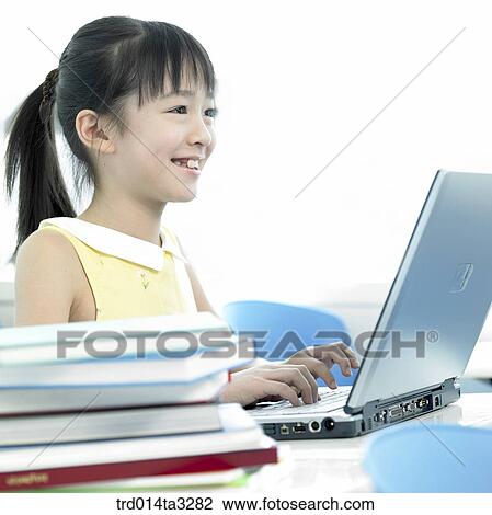 Girl using notebook computer View Large Photo Image Stock Image - Girl using notebook computer. Fotosearch