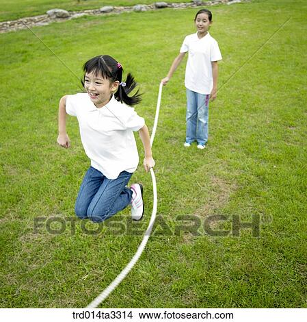 Girls jumping ropes at the park View Large Photo Image Picture - Girls jumping ropes at the park. Fotosearch