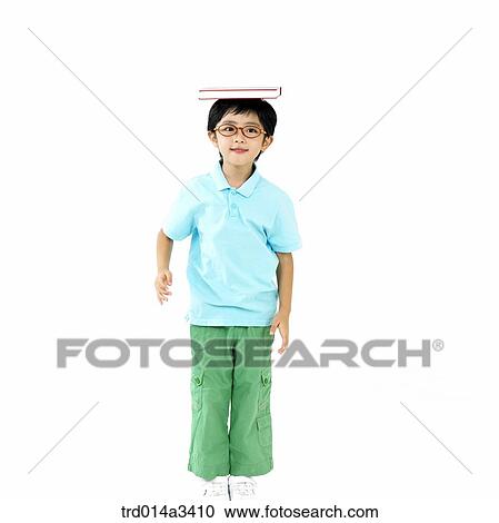 boy putting books on his head View Large Photo Image Stock Image - boy putting books on his head. Fotosearch