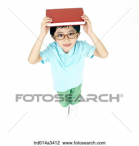boy putting books on his head View Large Photo Image Stock Image - boy putting books on his head. Fotosearch