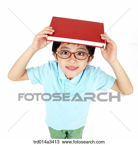 boy putting books on his head View Large Photo Image Stock Image - boy putting books on his head. Fotosearch