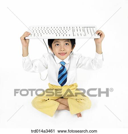 Boy putting keyboard on his head View Large Photo Image Stock Image - Boy putting keyboard on his head. Fotosearch
