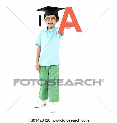 Stock Image - boy wearing graduation cap with holding Alphabet letters. Fotosearch
