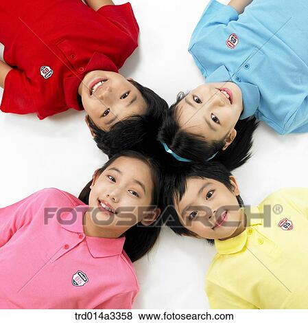 Children lying down View Large Photo Image Stock Photo - Children lying down. Fotosearch