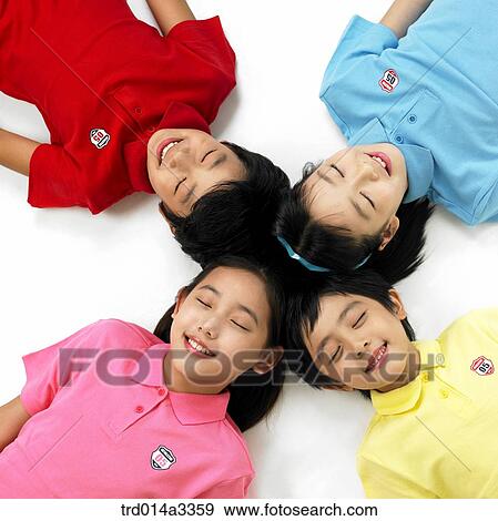Stock Photo - Children lying down withtheir eye closed. Fotosearch