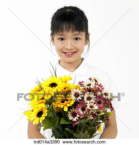 Stock Image - girl holding flowers. Fotosearch