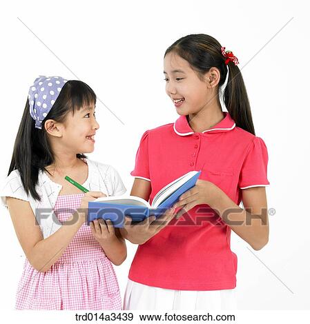 Stock Photo - girl in dialog while reading books. Fotosearch