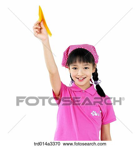 Stock Image - Girl playing with model plane. Fotosearch