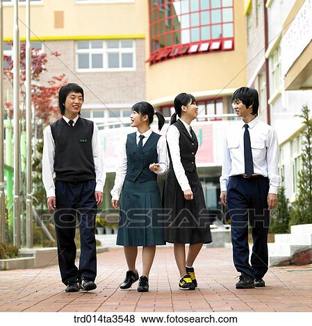 Chatting students while walking in school View Large Photo Image Stock Photo - Chatting students while walking in school. Fotosearch