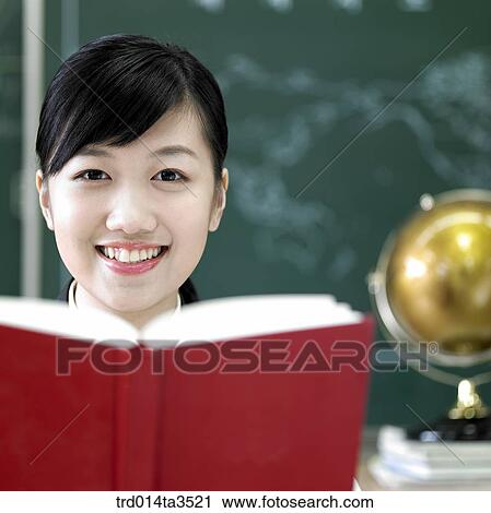 Closeup of studnets holding books at her desk View Large Photo Image Stock Image - Closeup of studnets holding books at her desk. Fotosearch
