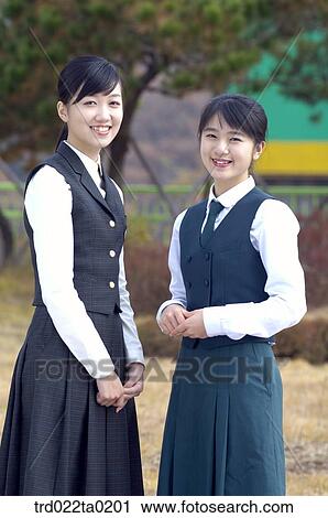 Stock Image - Smiling student in uniform in school. Fotosearch