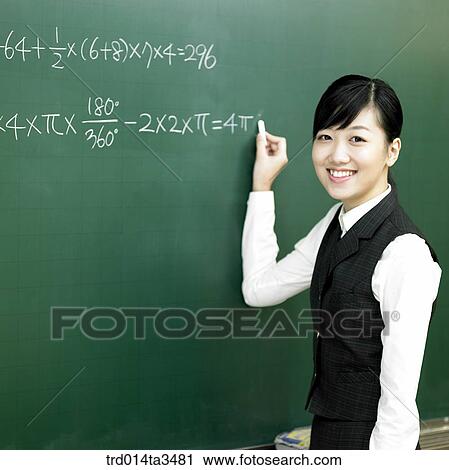 Stock Image - Solving math problem with chalk on the board. Fotosearch