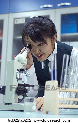 Stock Image - student doing chemistry experiment in the lab. Fotosearch