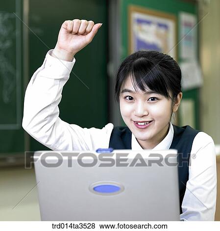 student raising hand at her desk View Large Photo Image Stock Photo - student raising hand at her desk. Fotosearch