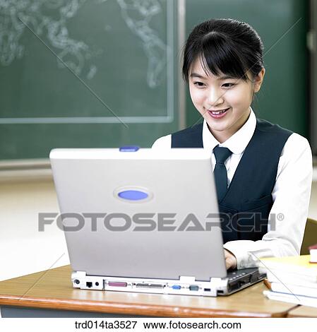 Stock Photo - Student using notebook computer in the classroom. Fotosearch