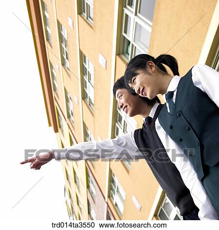 Stock Image - Students in uniform pointing out. Fotosearch