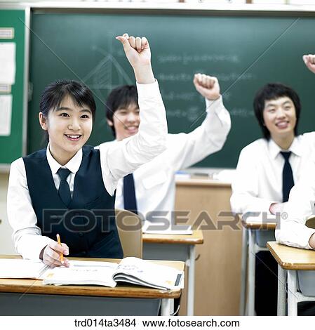 Students in uniform raising hands in the classroom View Large Photo Image Picture - Students in uniform raising hands in the classroom. Fotosearch