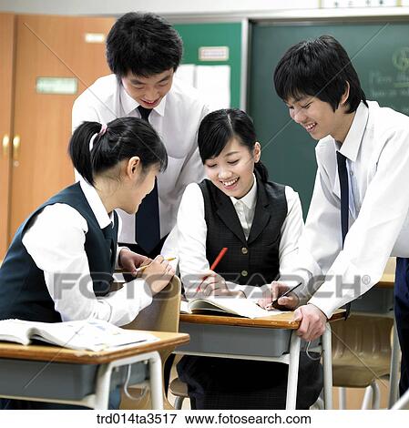 Studnets gathered at friend's desk for solving problem View Large Photo Image Stock Photo - Studnets gathered at friend's desk for solving problem. Fotosearch