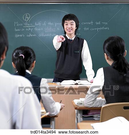 Studnets in uniform pointing his friend in English class in the classroom View Large Photo Image Picture - Studnets in uniform pointing his friend in English class in the classroom. Fotosearch