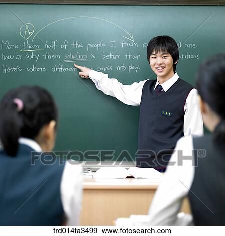 Studnets in uniform pointing his friend in English class in the classroom View Large Photo Image Stock Photo - Studnets in uniform pointing his friend in English class in the classroom. Fotosearch
