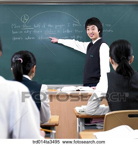 Studnets in uniform pointing his friend in English class in the classroom View Large Photo Image Stock Photography - Studnets in uniform pointing his friend in English class in the classroom. Fotosearch