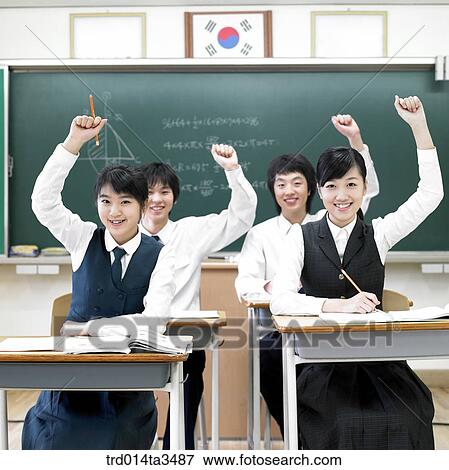 Studnets in uniform rasing hands for question View Large Photo Image Stock Photo - Studnets in uniform rasing hands for question. Fotosearch