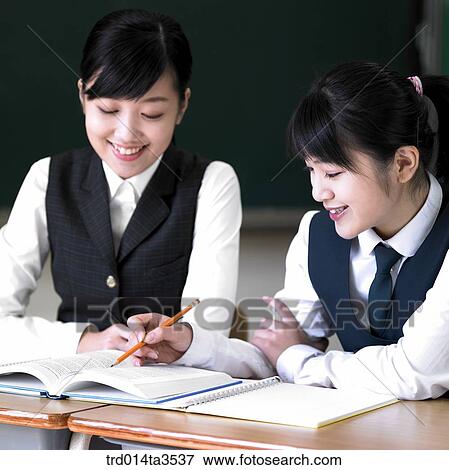 Studying student in uniform in the classroom View Large Photo Image Stock Photo - Studying student in uniform in the classroom. Fotosearch