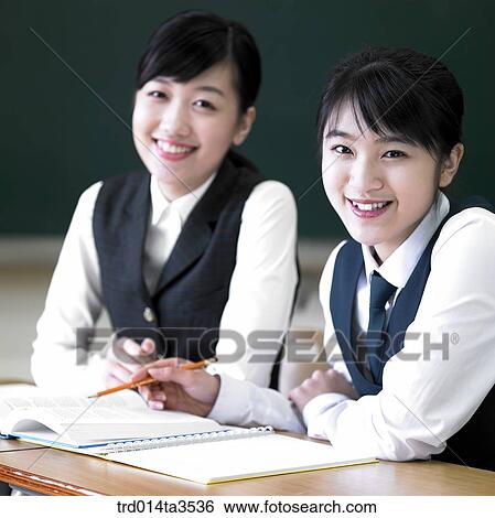Studying student in uniform in the classroom View Large Photo Image Stock Photograph - Studying student in uniform in the classroom. Fotosearch