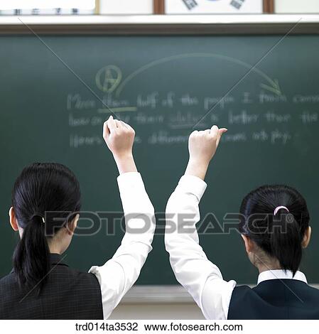 two students in uniform raising hand View Large Photo Image Stock Image - two students in uniform raising hand. Fotosearch